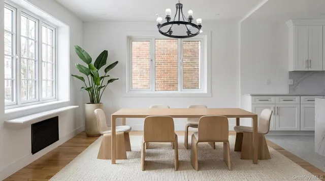 a dining room with furniture potted plants and wooden floor