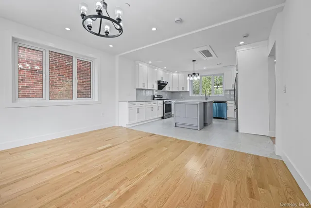 a kitchen with white cabinets stainless steel appliances and sink