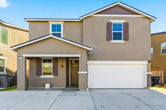 a front view of a house with a garage