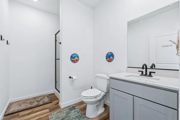 a bathroom with a toilet a sink and a mirror