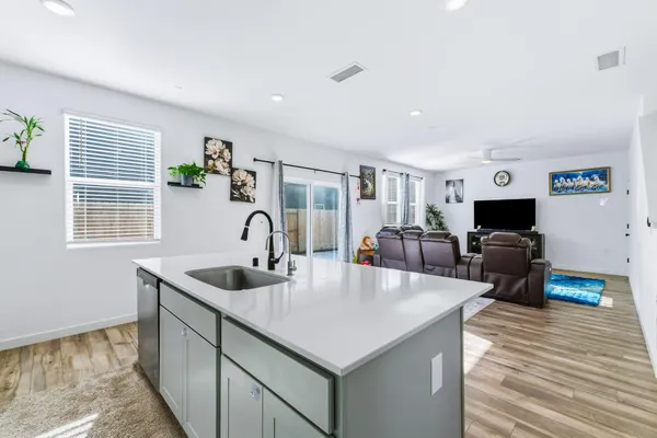 a kitchen with sink refrigerator and window