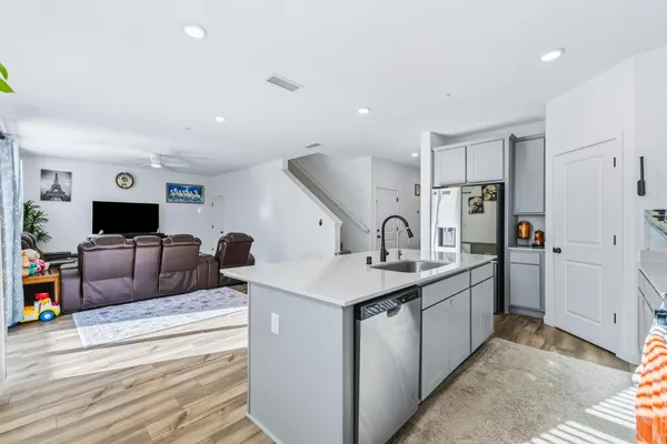 a view of living room kitchen with stainless steel appliances granite countertop living room