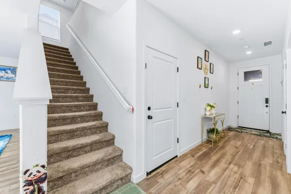 a view of a livingroom with stairs and furniture
