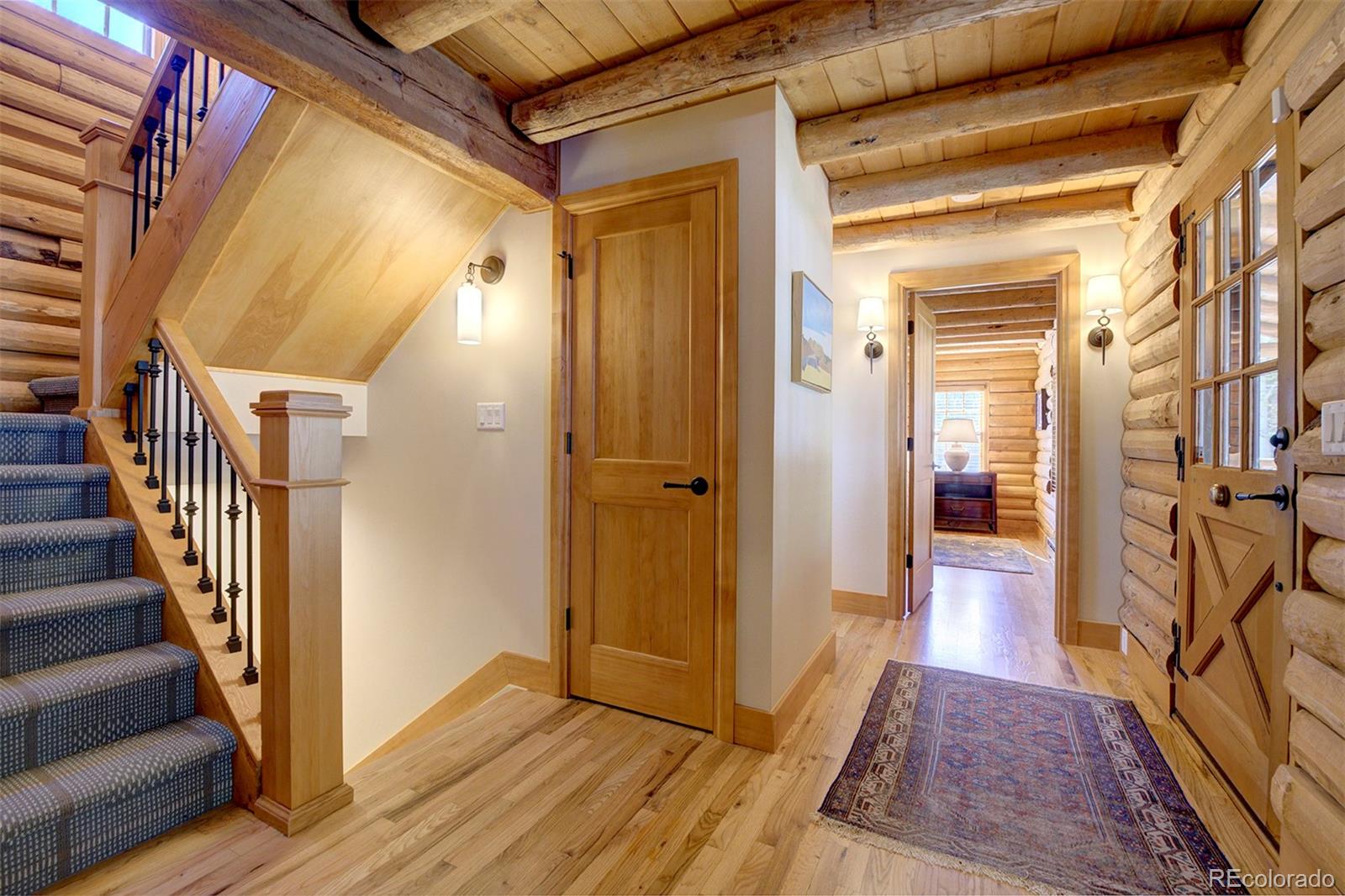 9670 South Warhawk Road Conifer, CO 80433 - Photo 12 of 40 a view of a hallway with wooden floor and staircase