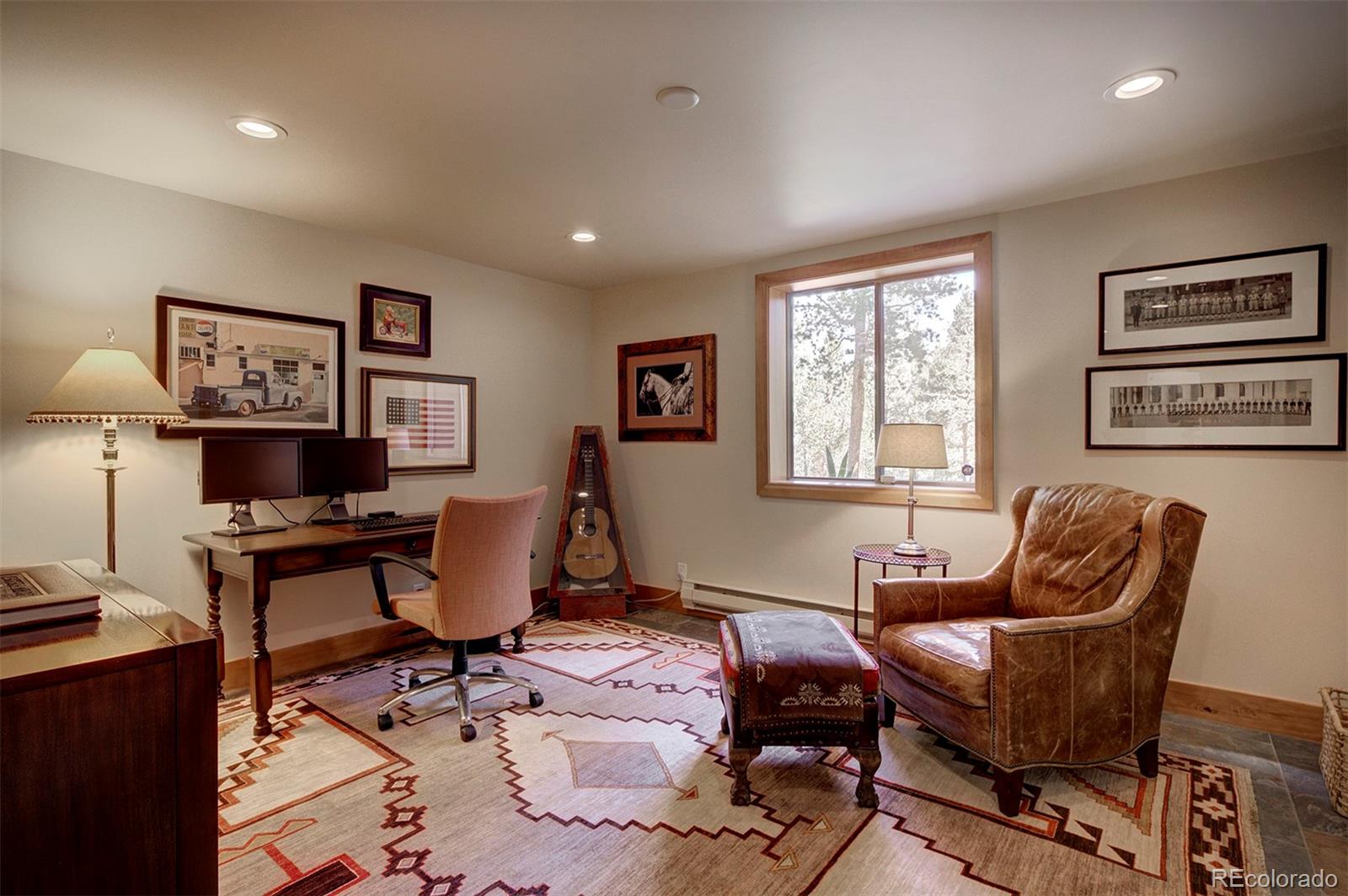9670 South Warhawk Road Conifer, CO 80433 - Photo 19 of 40 a living room with furniture a computer and a window