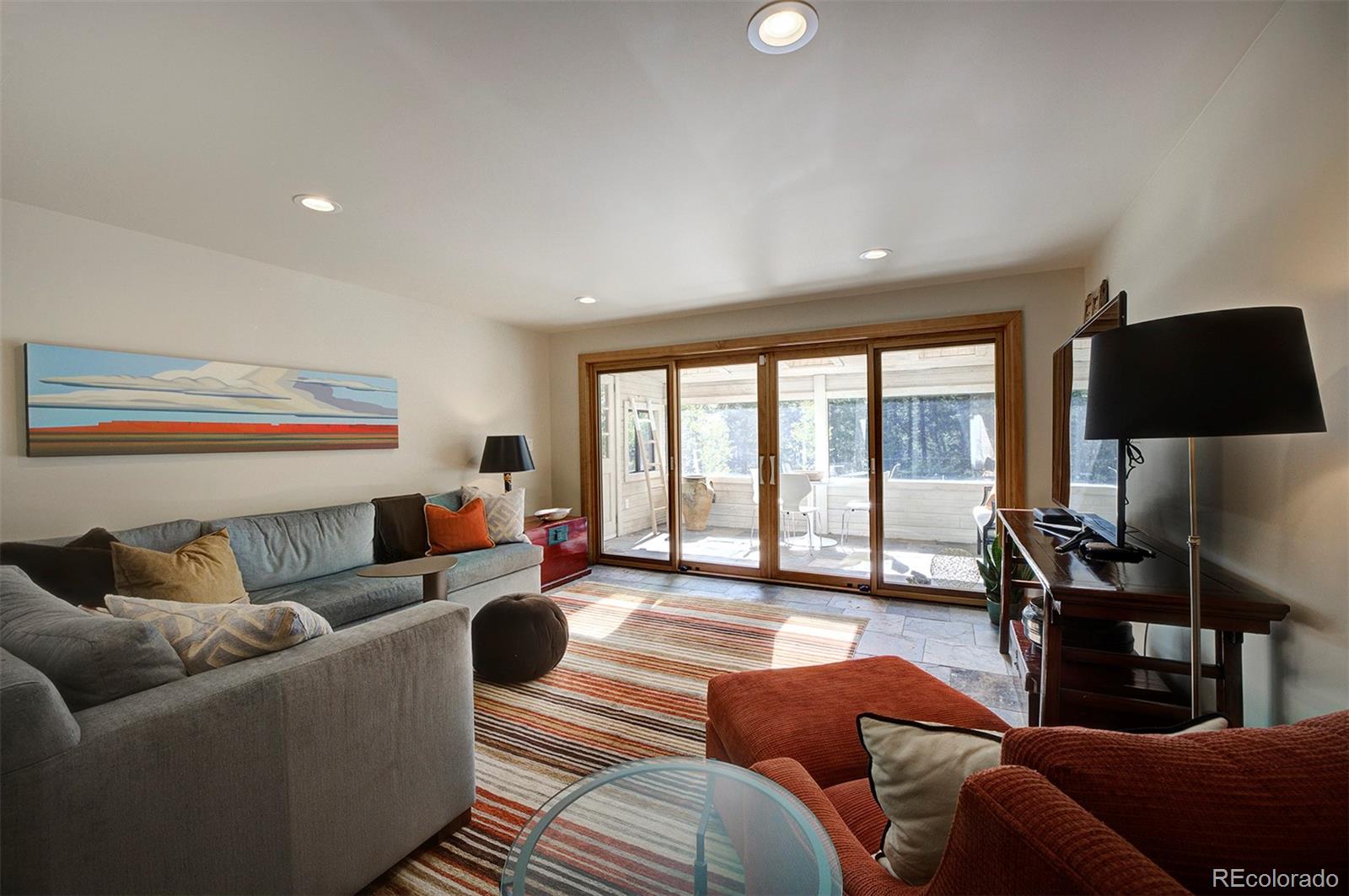 9670 South Warhawk Road Conifer, CO 80433 - Photo 24 of 40 a living room with furniture and a flat screen tv