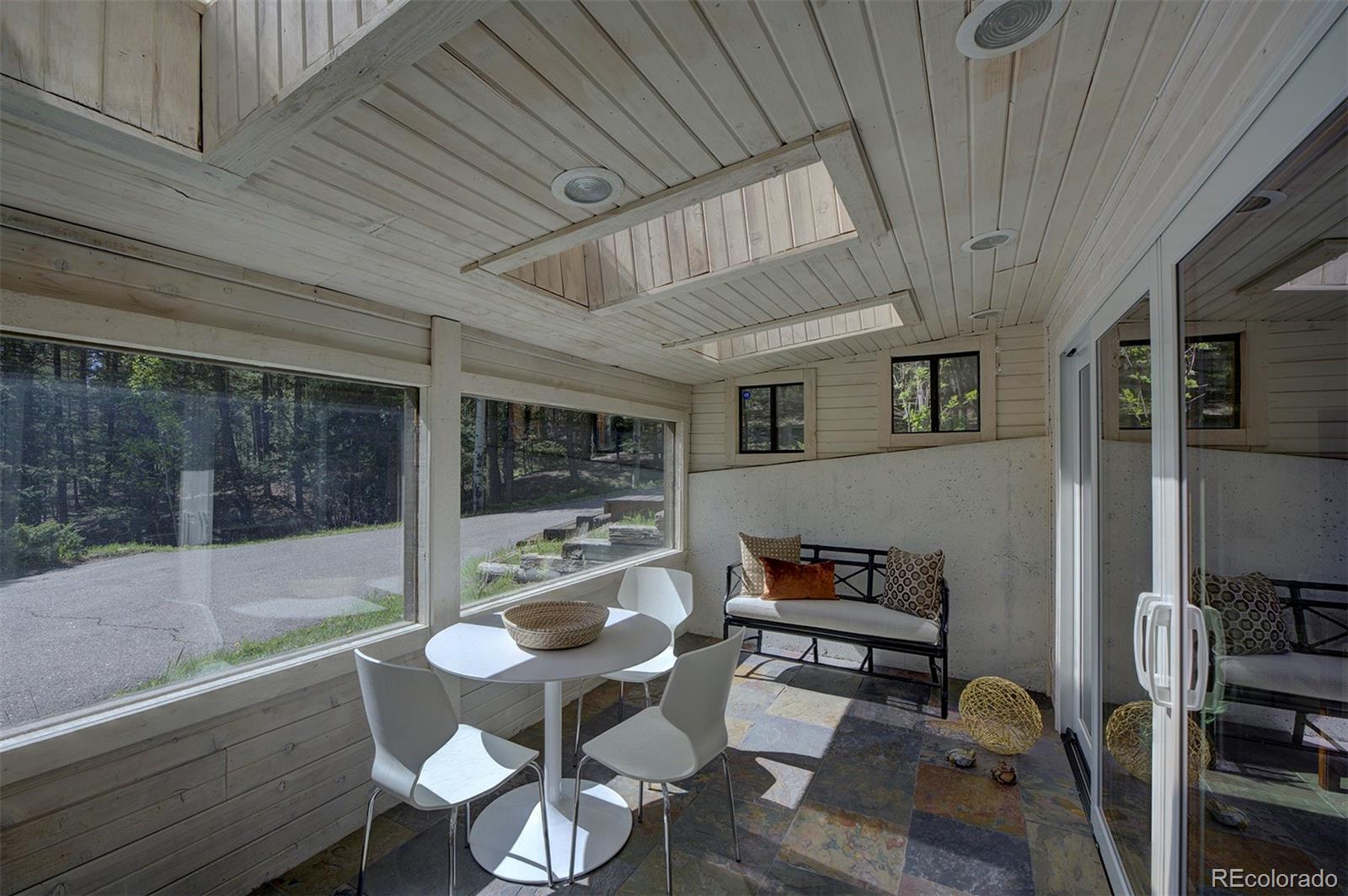 9670 South Warhawk Road Conifer, CO 80433 - Photo 25 of 40 a living room with furniture and a window