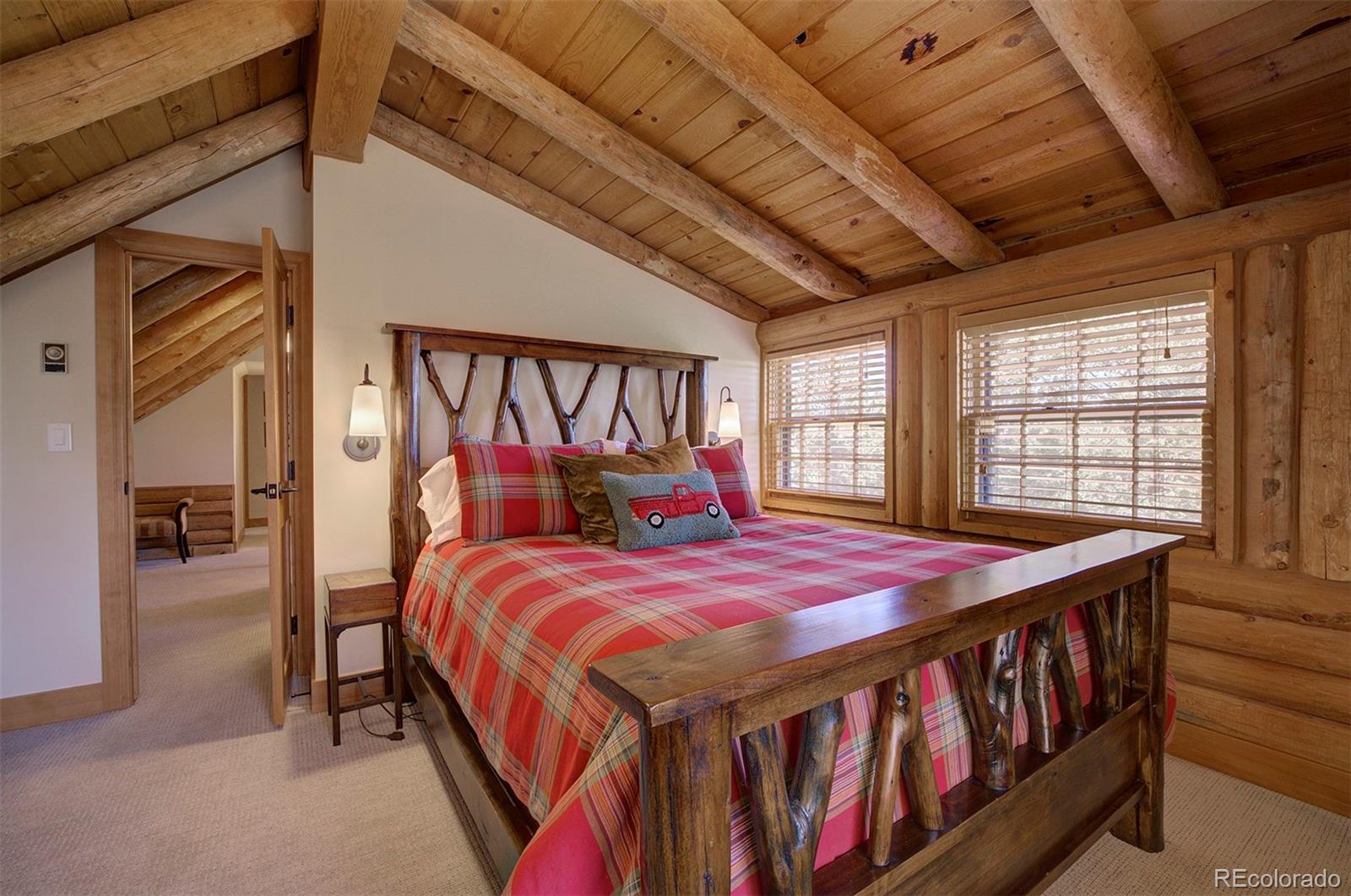 9670 South Warhawk Road Conifer, CO 80433 - Photo 28 of 40 a bedroom with a bed and a large window