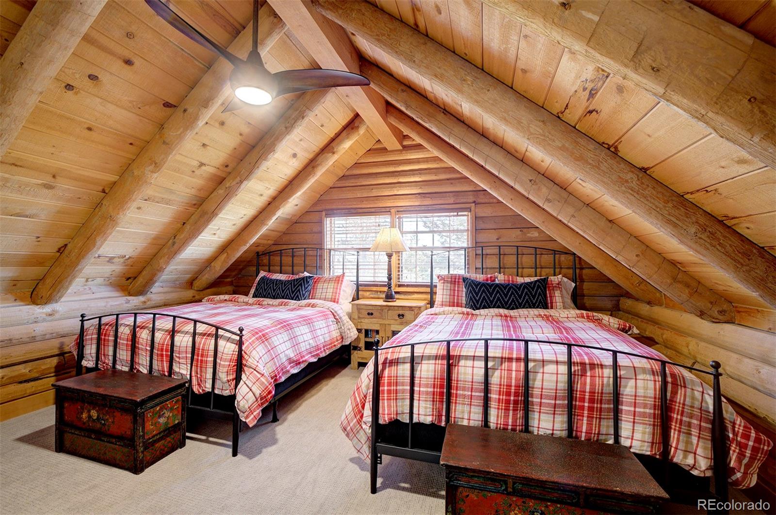 9670 South Warhawk Road Conifer, CO 80433 - Photo 30 of 40 a bedroom with furniture and a window