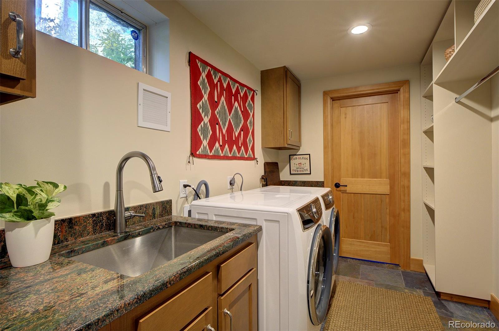 9670 South Warhawk Road Conifer, CO 80433 - Photo 32 of 40 a view of a kitchen with sink and washing machine