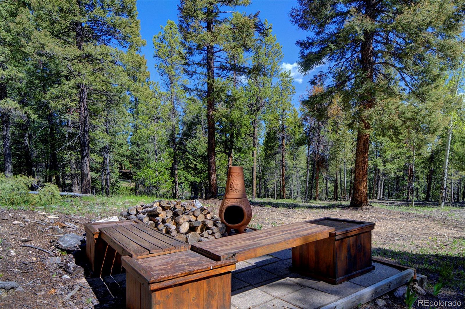 9670 South Warhawk Road Conifer, CO 80433 - Photo 36 of 40 a view of backyard with deck and outdoor seating