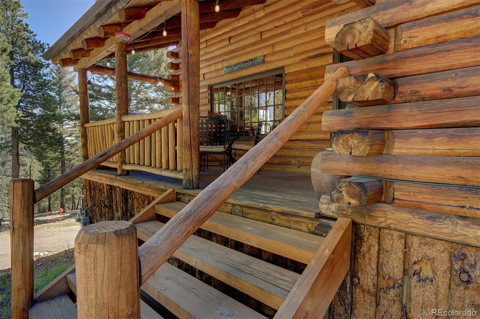 9670 South Warhawk Road Conifer, CO 80433 - Photo 39 of 40 a view of entryway with wooden floor and a front door
