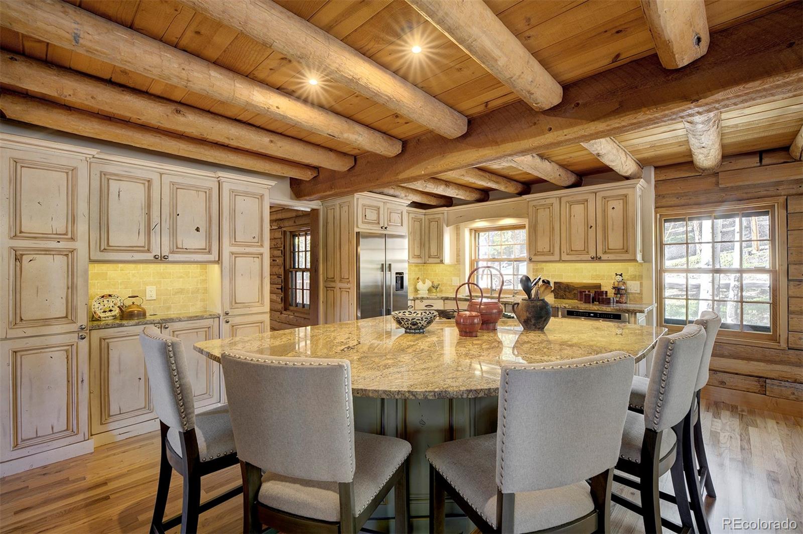 9670 South Warhawk Road Conifer, CO 80433 - Photo 6 of 40 a dining room with furniture a chandelier and wooden floor