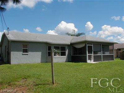 8382 Butternut Road Fort Myers, FL 33967 - Photo 2 of 10 a front view of a house with a yard and potted plants