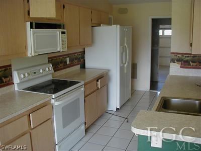 8382 Butternut Road Fort Myers, FL 33967 - Photo 9 of 10 a kitchen with a sink a stove and refrigerator