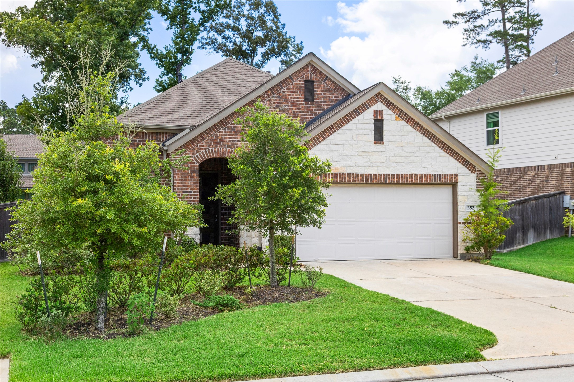 252 Scarlet Maple Way Conroe, TX 77318 - Photo 2 of 37 Lush green landscaping front and back