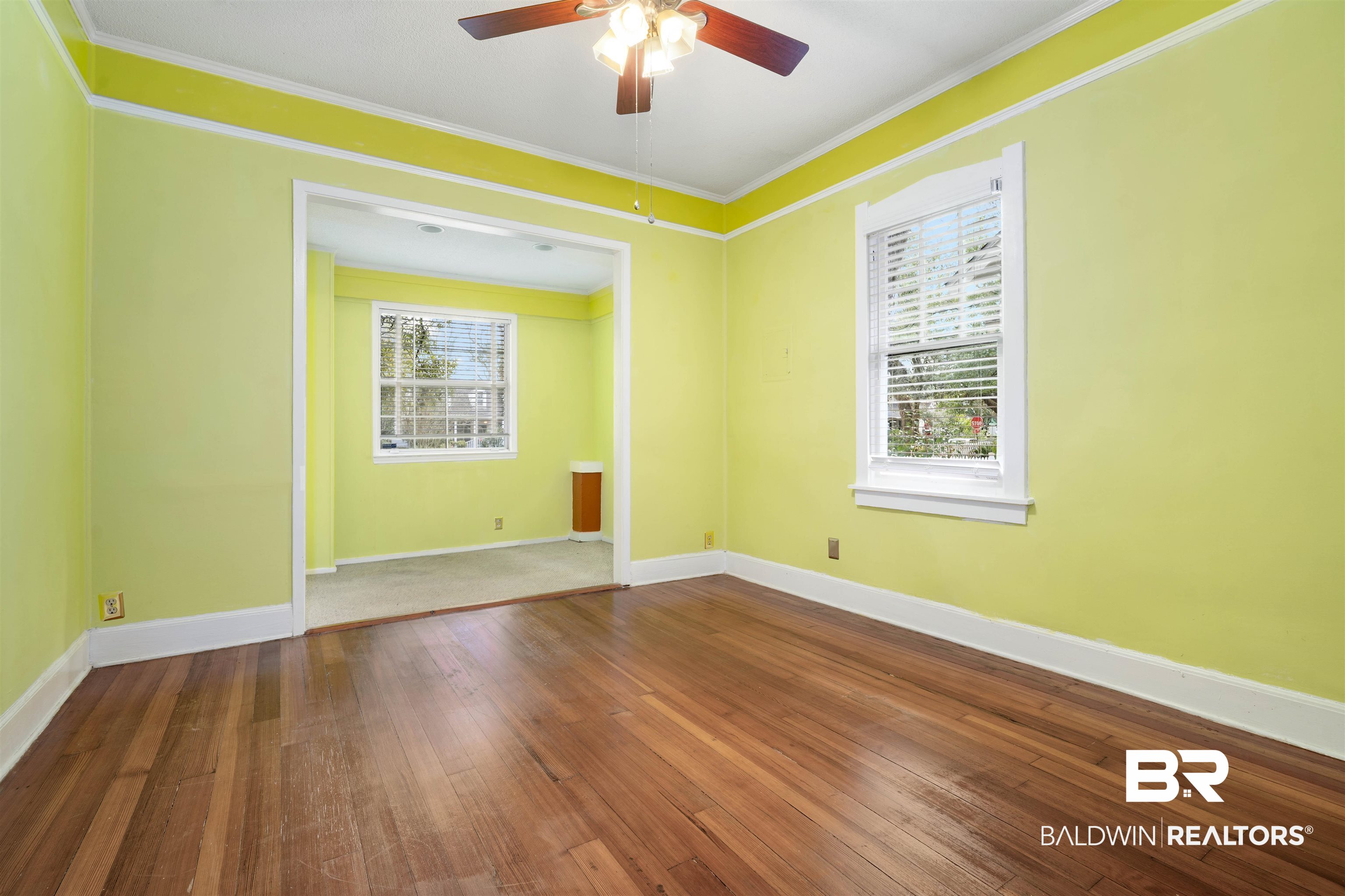 118 Mohawk Street Mobile, AL 36606 - Photo 11 of 26 Empty room featuring dark wood finished floors, ornamental molding, and ceiling fan