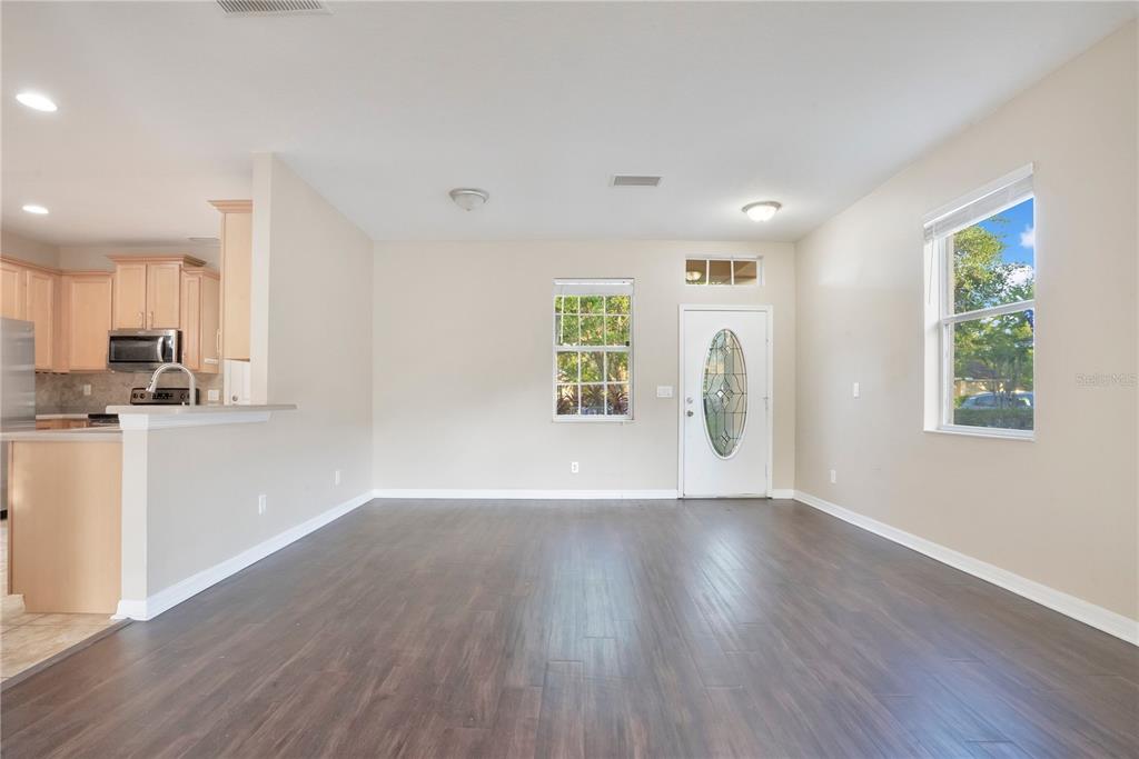 15031 Skip Jack Loop Lakewood Ranch, FL 34202 - Photo 3 of 27 a view of an empty room with window and wooden floor