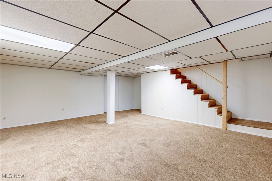 1723 Bantam Ridge Road Steubenville, OH 43953 - Photo 20 of 22 Finished basement featuring stairs, carpet floors, a drop ceiling, and visible vents