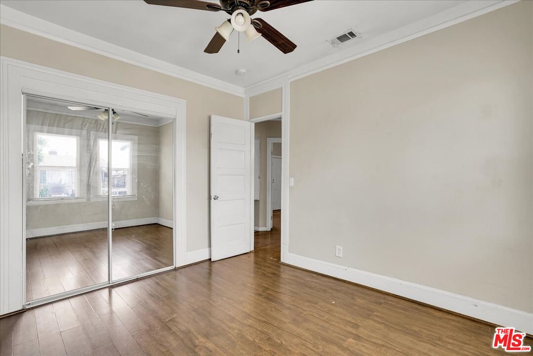 1221 West 152nd Street Compton, CA 90220 - Photo 11 of 20 a view of an empty room with wooden floor