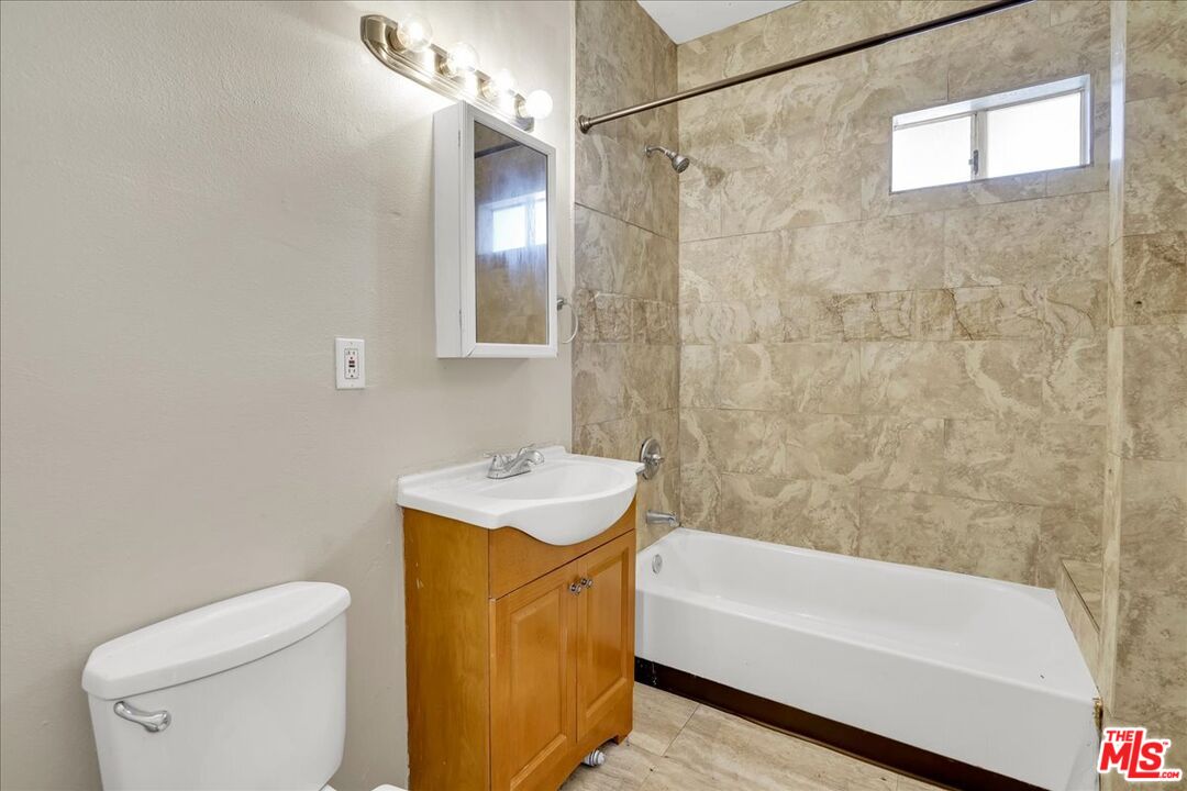 1221 West 152nd Street Compton, CA 90220 - Photo 12 of 20 a bathroom with a sink a toilet and shower