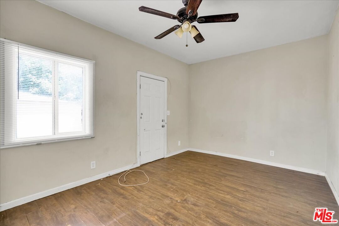 1221 West 152nd Street Compton, CA 90220 - Photo 15 of 20 an empty room with a window and a fan