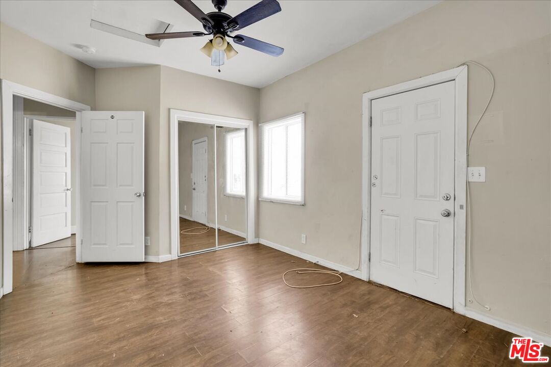 1221 West 152nd Street Compton, CA 90220 - Photo 16 of 20 a view of an empty room with window and wooden floor