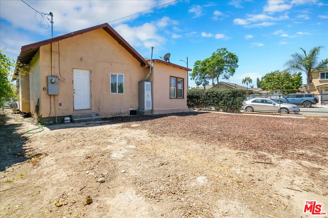 1221 West 152nd Street Compton, CA 90220 - Photo 19 of 20 a view of a house with backyard and trees