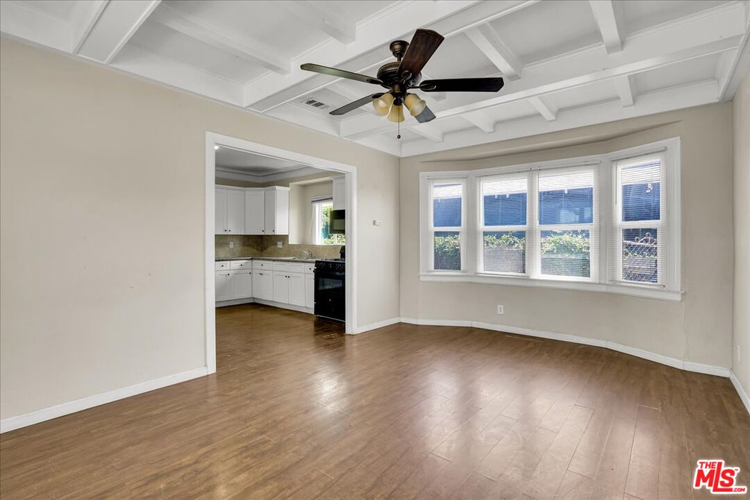 1221 West 152nd Street Compton, CA 90220 - Photo 3 of 20 a view of an empty room with a window and wooden floor