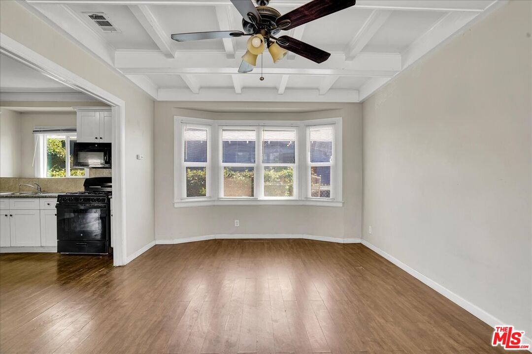 1221 West 152nd Street Compton, CA 90220 - Photo 4 of 20 a view of an empty room with a window and wooden floor
