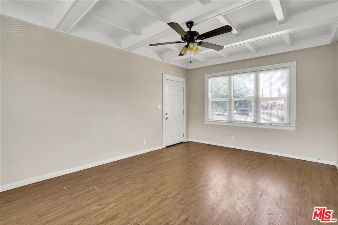 1221 West 152nd Street Compton, CA 90220 - Photo 5 of 20 wooden floor in an empty room with a window