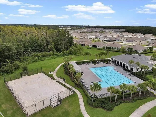 an aerial view of a house with yard swimming pool and outdoor seating
