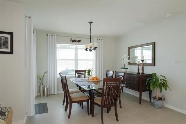 a dining room with furniture and window
