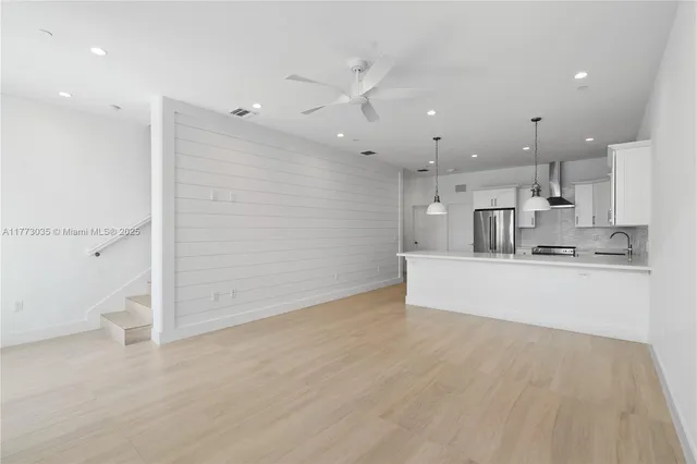a kitchen with stainless steel appliances a stove a sink and a cabinets