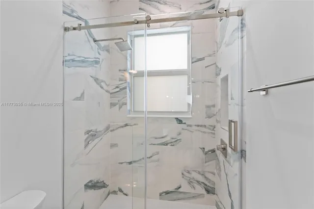 a bathroom with a shower and a toilet