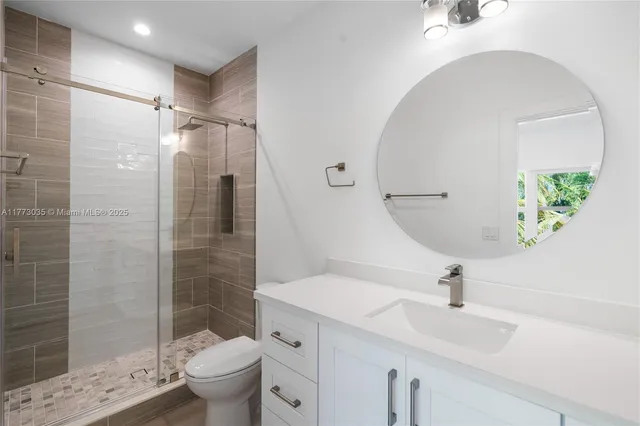 a bathroom with double vanity sinks and a mirror