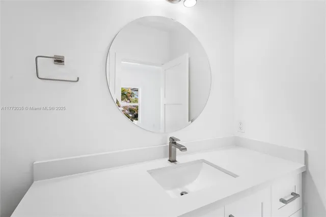 a bathroom with a shower sink vanity and mirror