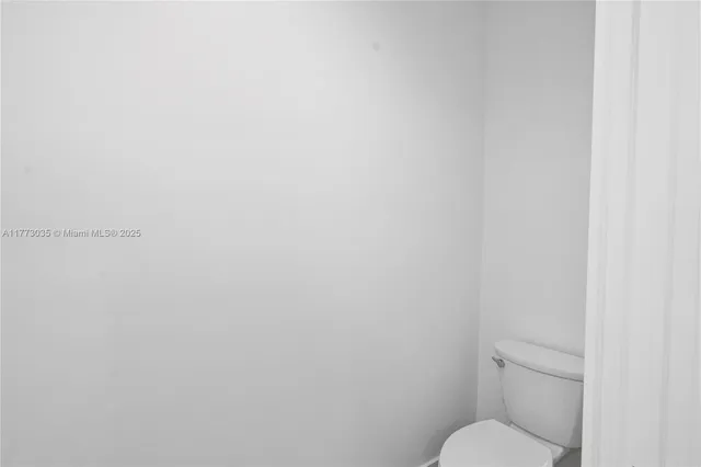 an aerial view of a house with a yard and lake view