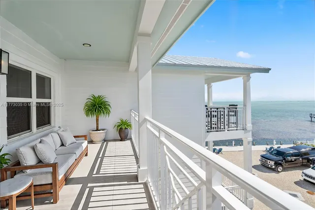 an aerial view of ocean with residential house and outdoor space