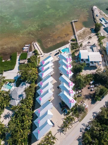 an aerial view of residential houses with outdoor space
