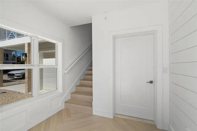 a kitchen with stainless steel appliances granite countertop a sink a stove a refrigerator and cabinets