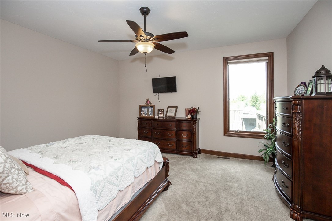 9155 Shank Road Litchfield, OH 44253 - Photo 22 of 47 Bedroom featuring light carpet and a ceiling fan