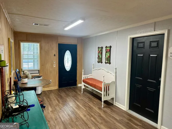 a bedroom with a bed and a large mirror