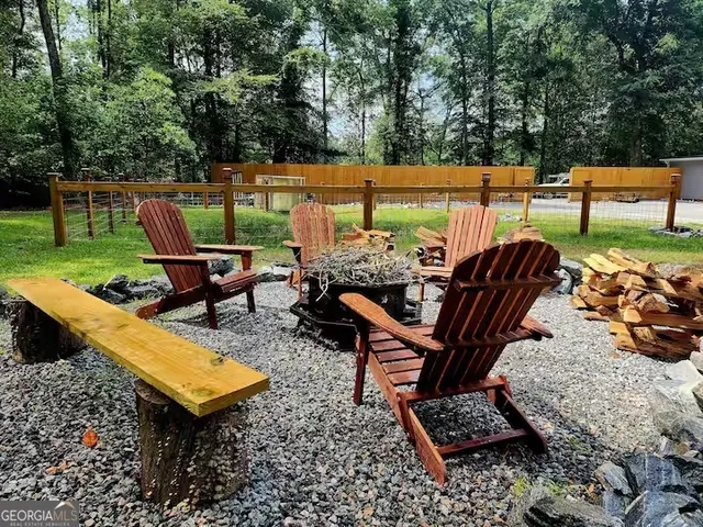 a view of a patio with table and chairs with wooden floor and plants