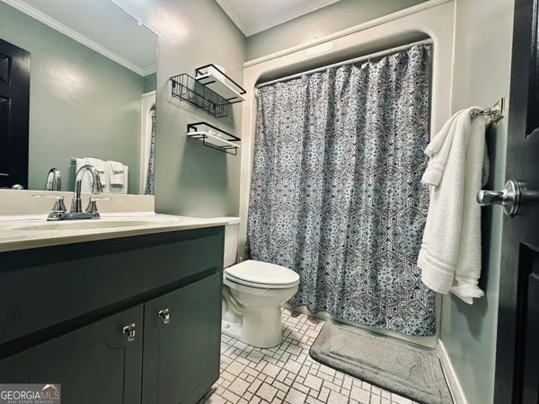 a kitchen with a dining table chairs and refrigerator