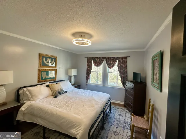 a bedroom with a bed and dresser