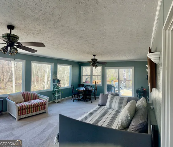 a kitchen with stainless steel appliances wooden floors wooden cabinets a refrigerator and a sink