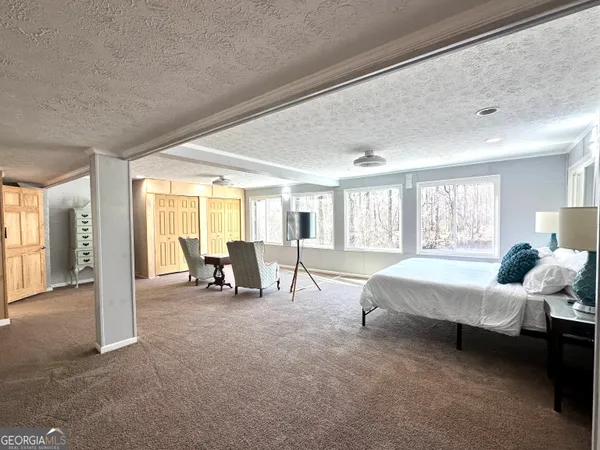 a bedroom with a bed and window