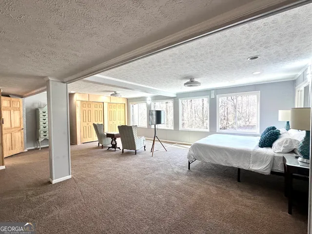 a bedroom with a bed and window