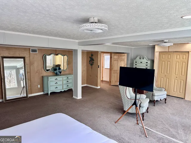 a bedroom with a bed and a night stand